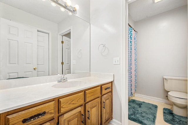 full bathroom featuring vanity, tile patterned flooring, baseboards, and toilet