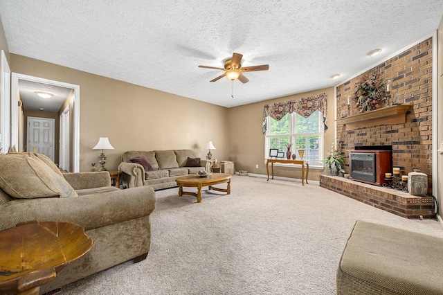 carpeted living room with baseboards, a textured ceiling, ceiling fan, and a fireplace