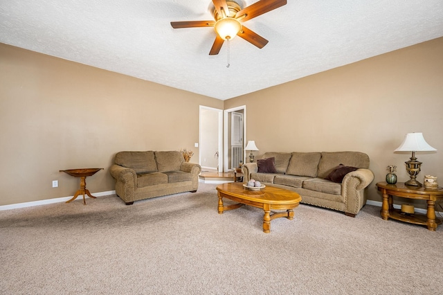 carpeted living area featuring a ceiling fan, baseboards, and a textured ceiling