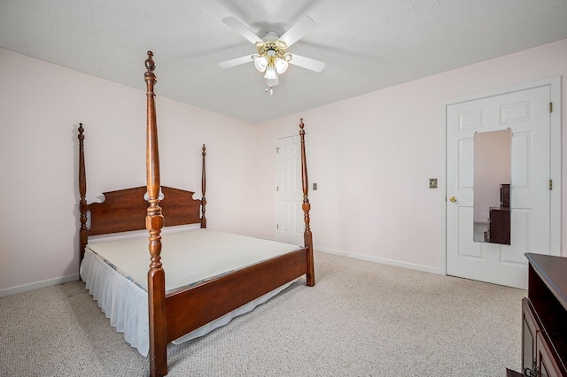 bedroom featuring baseboards, light carpet, and ceiling fan