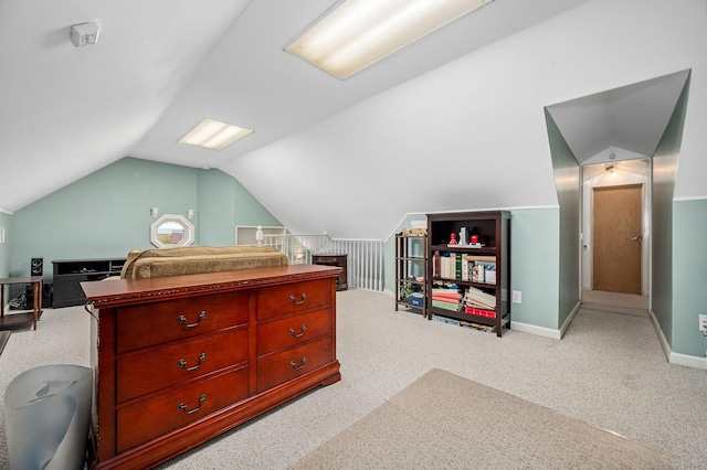 carpeted bedroom featuring baseboards and vaulted ceiling