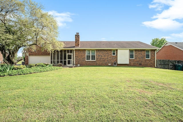 rear view of property with a lawn, a sunroom, fence, and a chimney