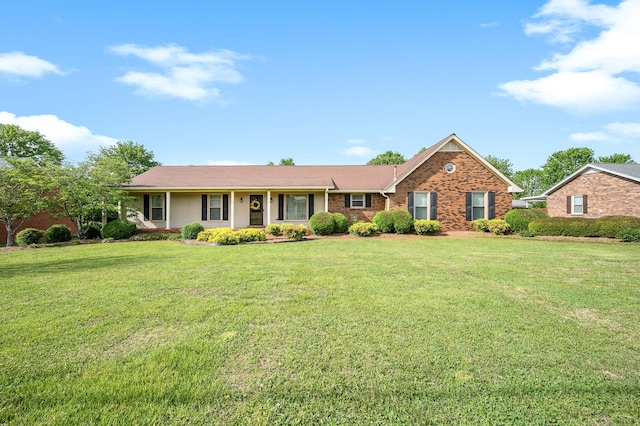 single story home featuring brick siding and a front yard