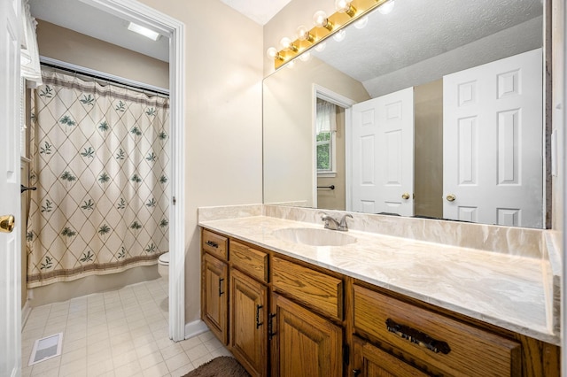 full bathroom with vanity, visible vents, toilet, tile patterned floors, and shower / bath combo