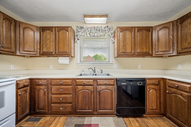 kitchen with a sink, white range with electric stovetop, a textured ceiling, and dishwasher