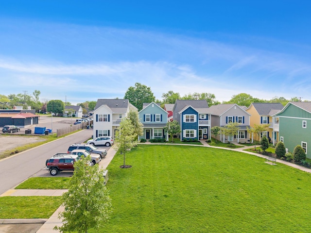 view of front of home with uncovered parking, a residential view, and a front lawn