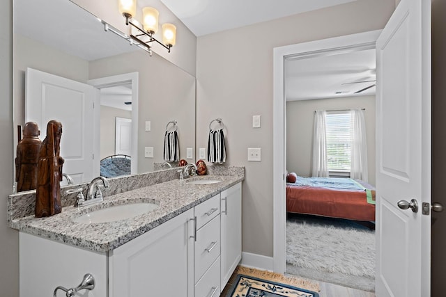 bathroom featuring connected bathroom, double vanity, and a sink