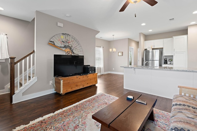 living area featuring stairs, a ceiling fan, recessed lighting, and dark wood-style floors
