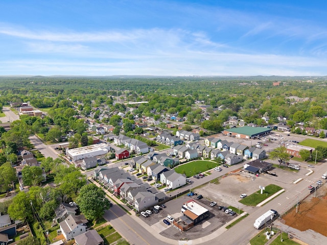 drone / aerial view featuring a residential view and a forest view