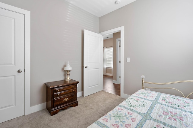 carpeted bedroom featuring baseboards