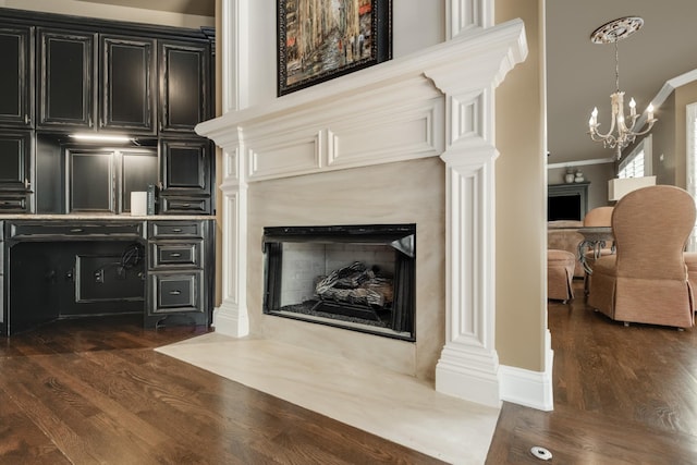 1136 Haverhill Dr, Brentwood, TN 37027 - living room with a premium fireplace, dark wood-style flooring, a chandelier, and crown molding