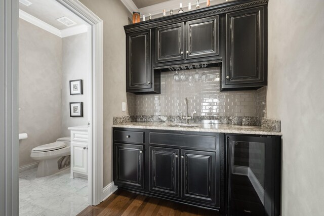1136 Haverhill Dr, Brentwood, TN 37027 - indoor wet bar featuring wine cooler, ornamental molding, and tasteful backsplash