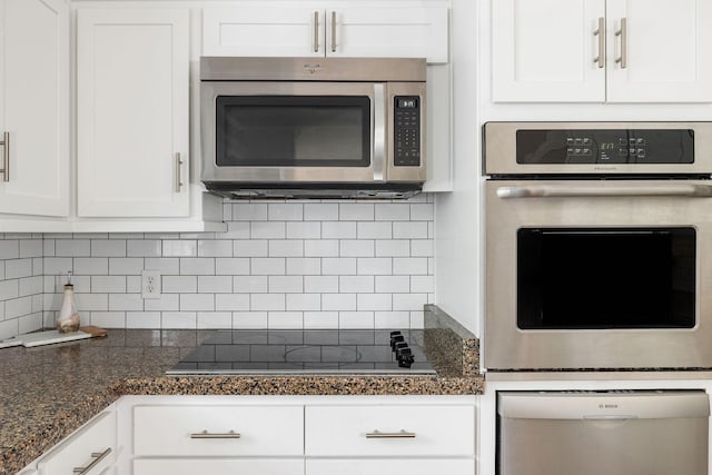 kitchen with appliances with stainless steel finishes, backsplash, and white cabinets