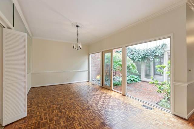 unfurnished dining area with visible vents, baseboards, crown molding, and an inviting chandelier
