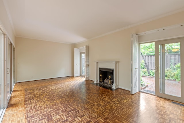 unfurnished living room with baseboards, crown molding, visible vents, and a fireplace