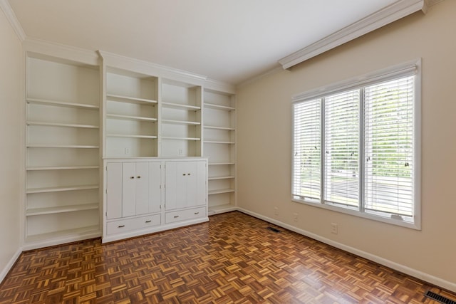 unfurnished bedroom featuring visible vents, ornamental molding, and baseboards