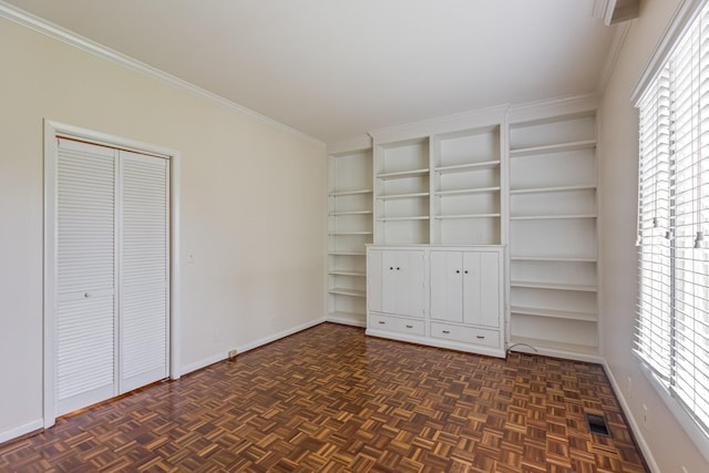 unfurnished bedroom featuring baseboards and ornamental molding