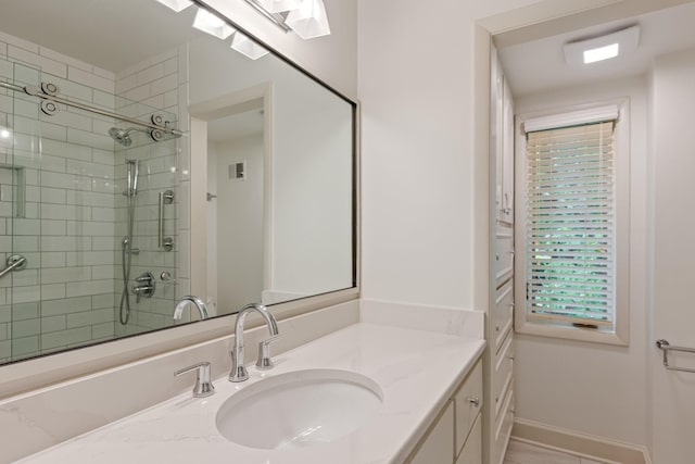 full bath with vanity, baseboards, and a shower stall