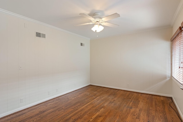 spare room with crown molding, a ceiling fan, wood finished floors, and visible vents