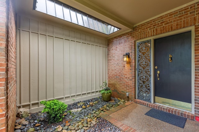 doorway to property featuring brick siding