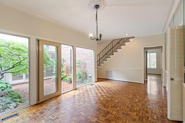 interior space with an inviting chandelier, ornamental molding, stairs, and visible vents