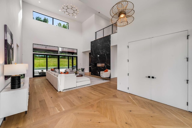 interior space with recessed lighting, a chandelier, a healthy amount of sunlight, and a towering ceiling