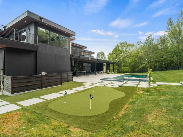 view of home's community with a patio area, fence, a yard, and a pool