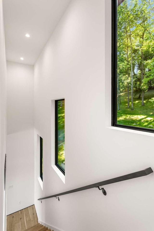 stairs featuring recessed lighting and wood finished floors