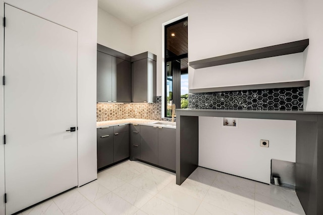 clothes washing area with cabinet space, washer hookup, a sink, marble finish floor, and electric dryer hookup