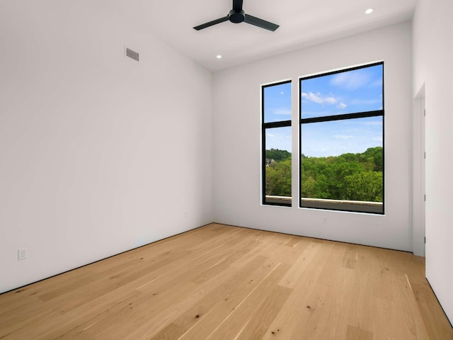 unfurnished room with recessed lighting, light wood finished floors, ceiling fan, and visible vents