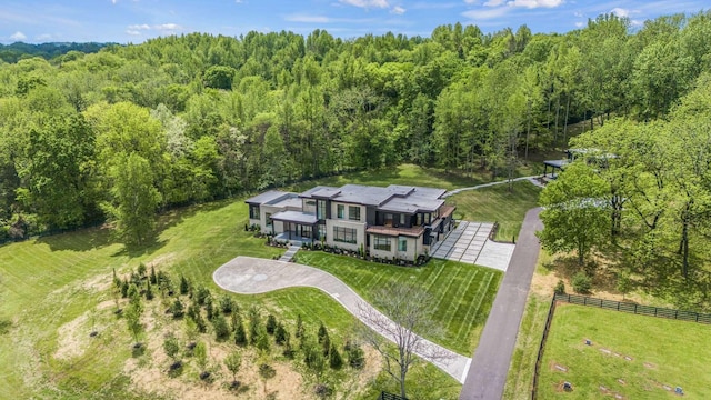 drone / aerial view with a wooded view