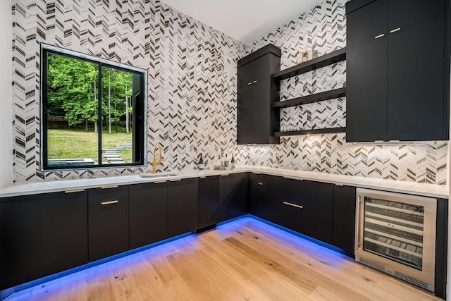 kitchen with beverage cooler, open shelves, dark cabinets, and modern cabinets