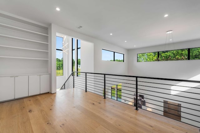 interior space with recessed lighting, wood finished floors, and visible vents