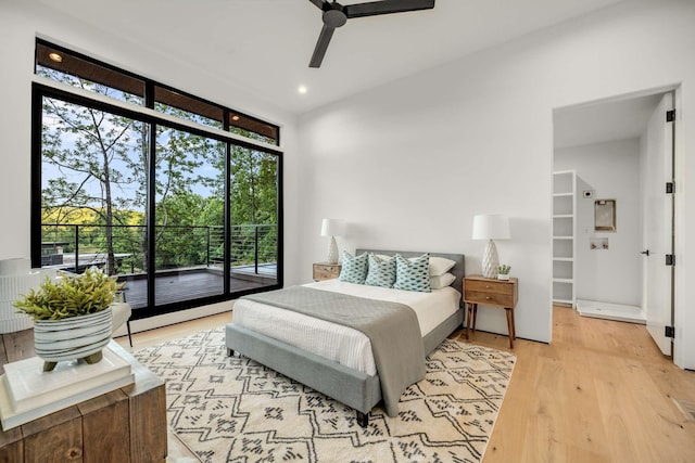 bedroom with a ceiling fan, light wood-style flooring, a wall of windows, and access to exterior