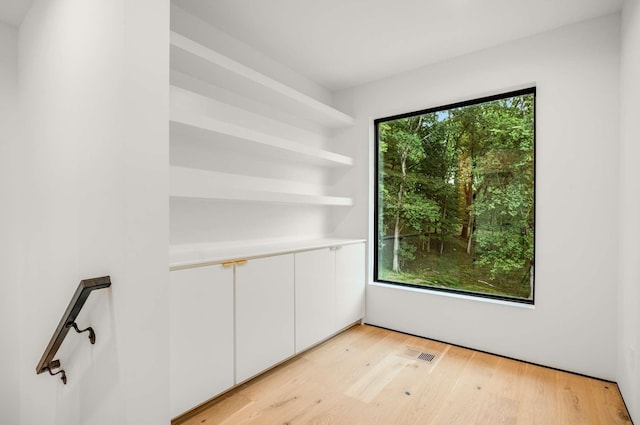 empty room with visible vents and light wood finished floors