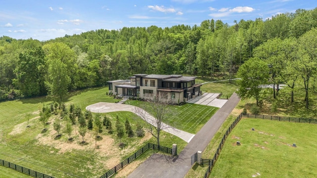 birds eye view of property featuring a rural view and a forest view