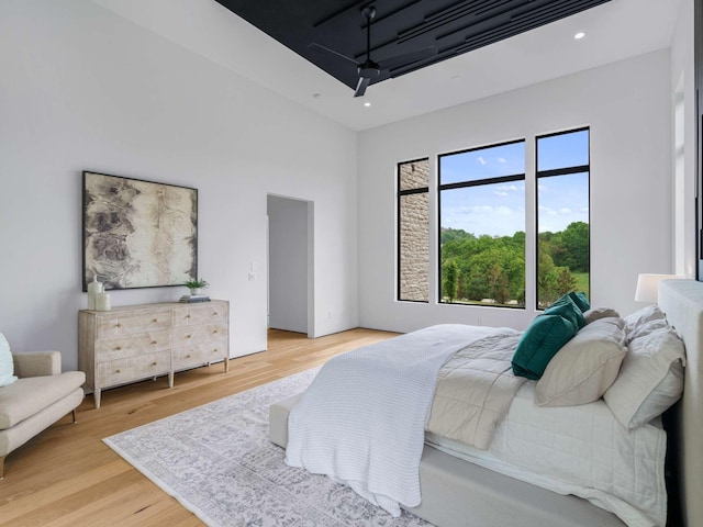 bedroom with recessed lighting and wood finished floors