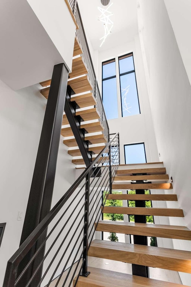stairway featuring a high ceiling