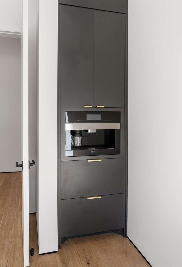 room details with stainless steel oven and wood finished floors