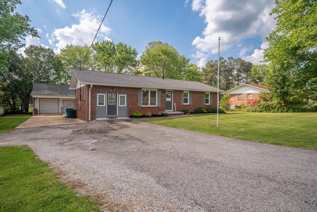ranch-style house with brick siding, gravel driveway, and a front lawn