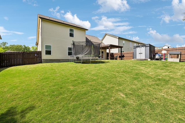 411 Barbaro Ct, Burns, TN 37029 - back of property featuring a lawn, a trampoline, and a shed