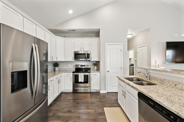 411 Barbaro Ct, Burns, TN 37029 - kitchen with a sink, vaulted ceiling, stainless steel appliances, and white cabinetry