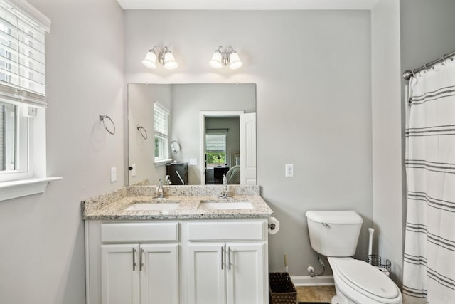 411 Barbaro Ct, Burns, TN 37029 - bathroom featuring a sink, baseboards, toilet, and double vanity