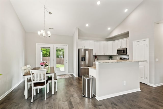 411 Barbaro Ct, Burns, TN 37029 - kitchen with a center island, dark wood finished floors, white cabinets, an inviting chandelier, and stainless steel appliances