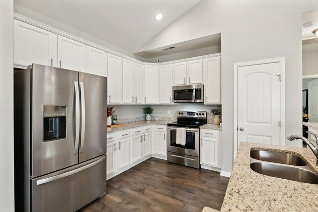 411 Barbaro Ct, Burns, TN 37029 - kitchen with stainless steel appliances, white cabinetry, a sink, and lofted ceiling