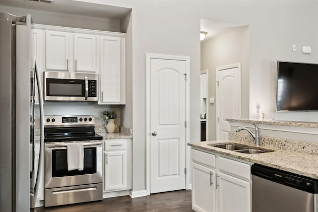 411 Barbaro Ct, Burns, TN 37029 - kitchen featuring dark wood-type flooring, a sink, white cabinetry, and appliances with stainless steel finishes
