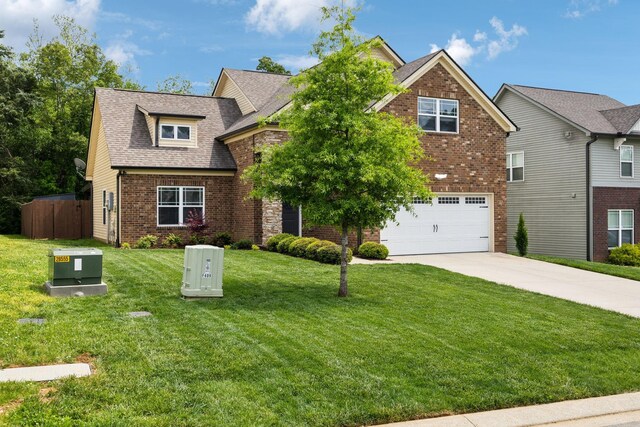 411 Barbaro Ct, Burns, TN 37029 - view of front of house featuring a garage, brick siding, fence, a front lawn, and concrete driveway