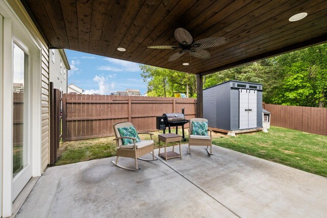 411 Barbaro Ct, Burns, TN 37029 - view of patio with a storage shed, ceiling fan, an outbuilding, and a fenced backyard