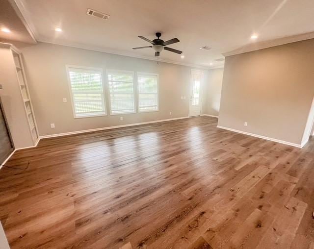 empty room with crown molding, recessed lighting, ceiling fan, and visible vents