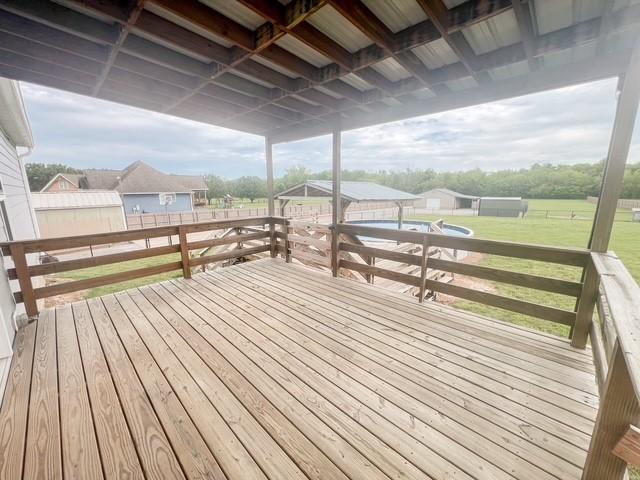 wooden terrace with a lawn